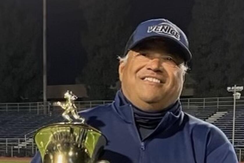 Venice coach Angelo Gasca showing off City Division I title trophy in 2021.