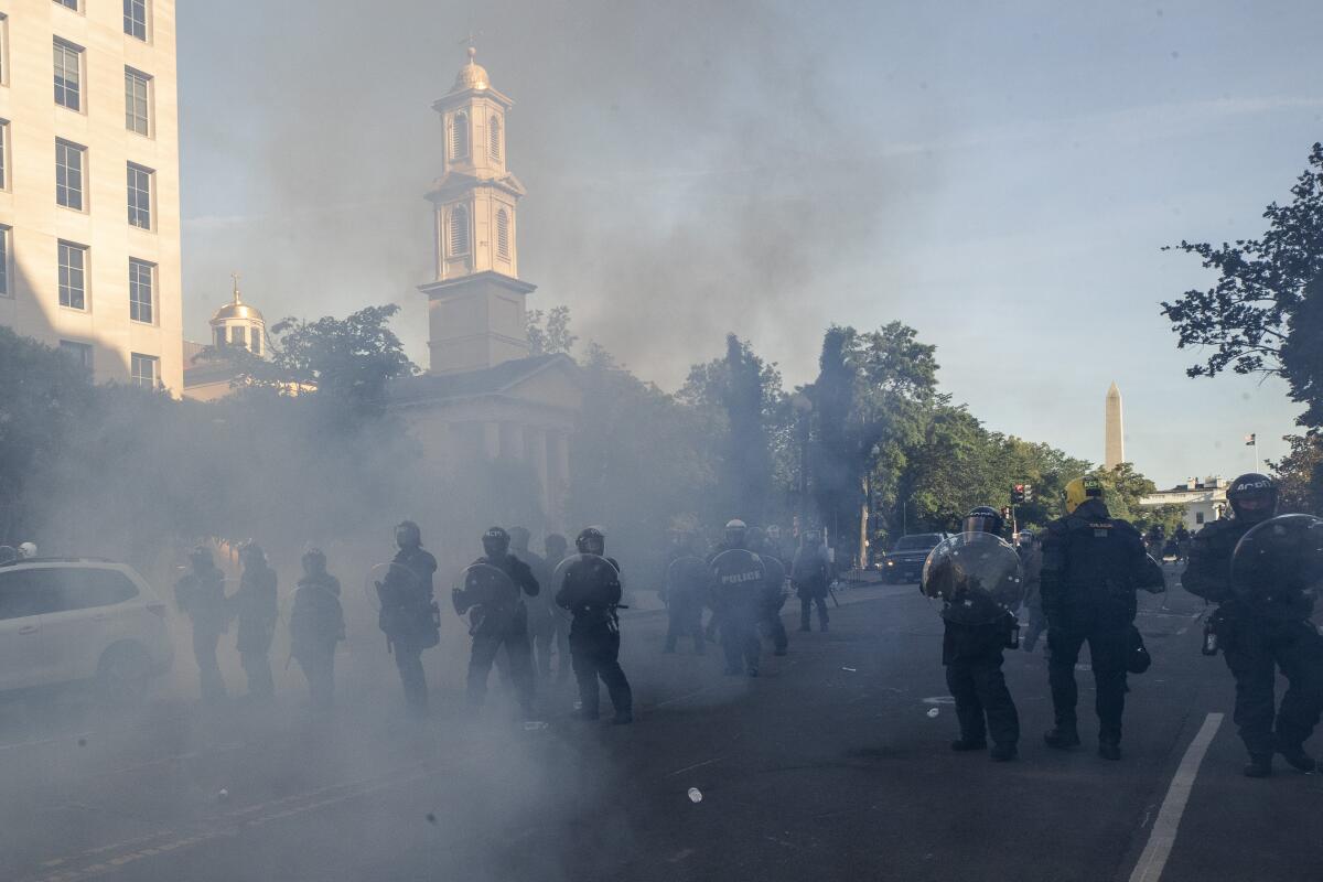 Law enforcement officers move on protesters in Lafayette Square in Washington, D.C.