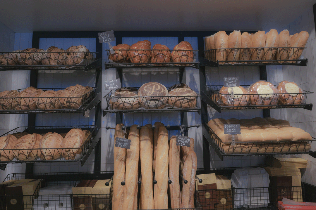 An animation of a person walking past racks containing various shapes of bread.