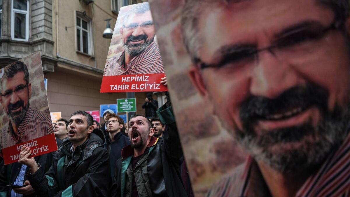 Demonstrators hold portraits of Tahir Elci, a slain human rights lawyer, during a Jan. 24, 2019, protest in Istanbul, Turkey. The 2015 shooting was filmed, but no arrests were made.