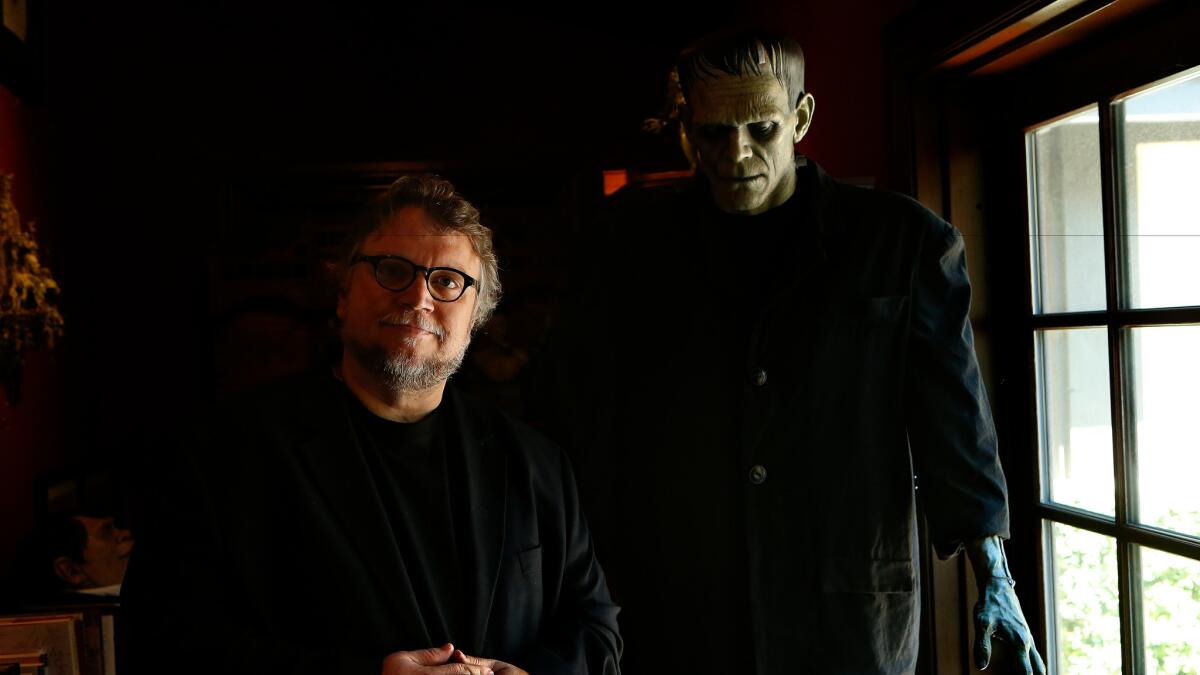 Guillermo del Toro and his 7-foot sculpture of Boris Karloff as Frankenstein’s monster by artist Mike Hill.