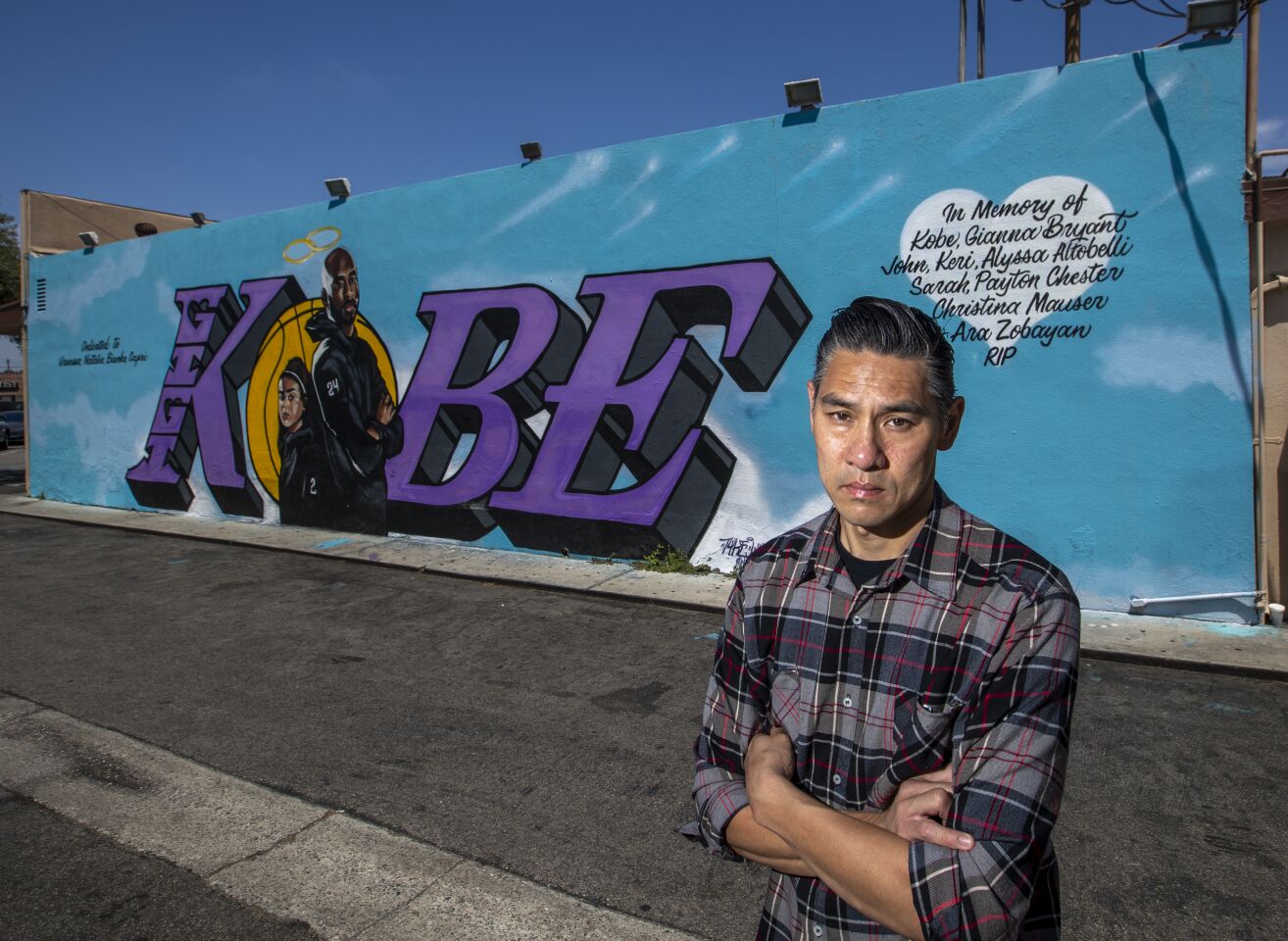 Mural artist Tyke Witnes in front of his mural at El Toro Bravo Tortilleria in Costa Mesa.
