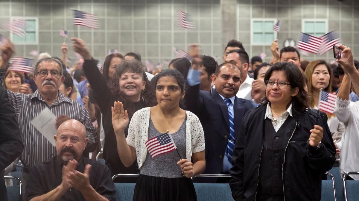 A group of people take the citizenship oath during naturalization ceremonies at a U.S. Citizenship and Immigration Services ceremony in Los Angeles on Sept. 20.