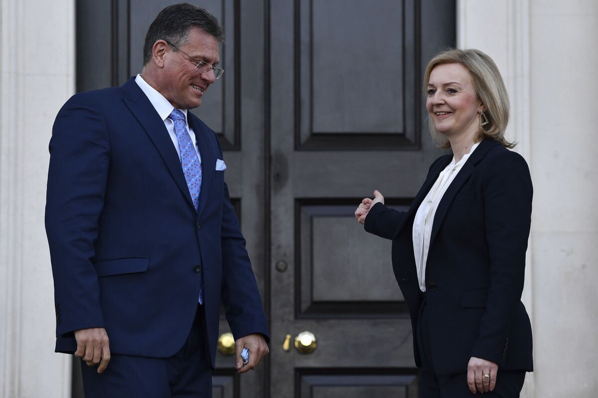 Foreign Secretary Liz Truss, left, greets EU post-Brexit negotiator Maros Sefcovic as he arrives for a meeting at Chevening in Kent, England, Thursday, Jan. 13, 2022. Top negotiators from Britain and the European Union are meeting in hope of resolving their a thorny dispute over Northern Ireland trade. (Ben Stanstall/Pool Photo via AP)