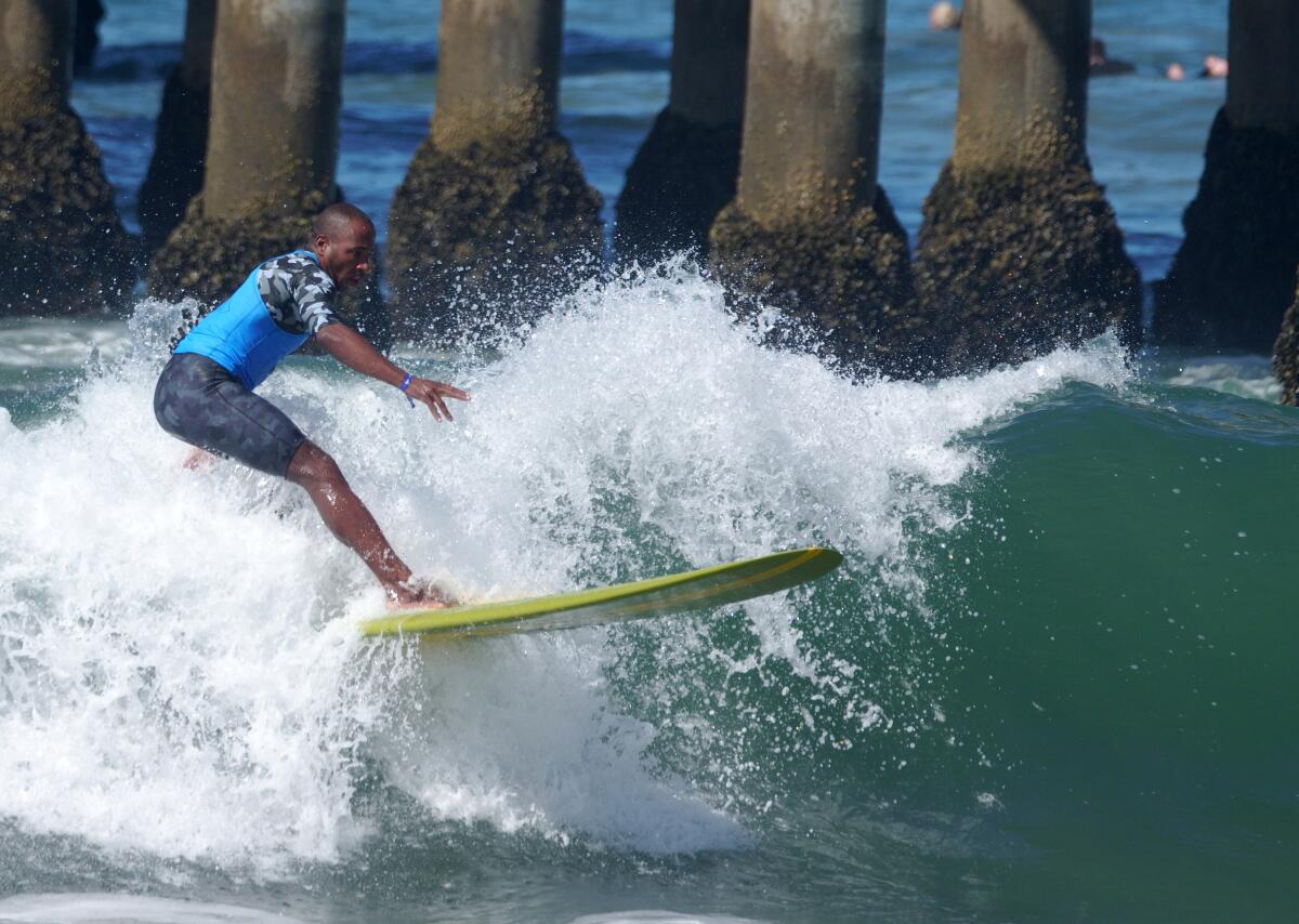 Jefson Silva of Brazil rides the longboard during the U.S. Open of Surfing, in Huntington Beach on Friday.