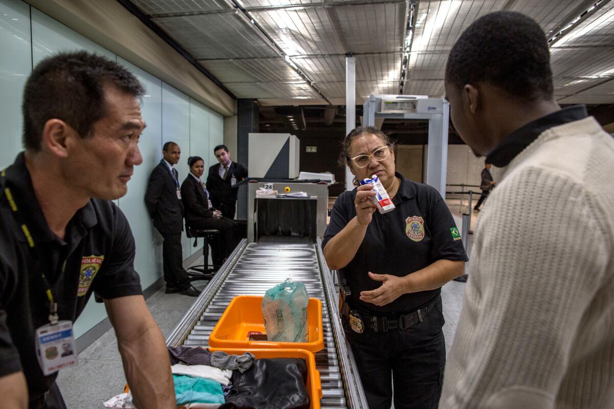 Federal agent Elza Lucia de Melo questions Emmanuel, a Nigerian, about a laxative drug used by traffickers who swallow drugs and try to travel through the International Airport of Guarulhos in Sao Paulo, Brazil.