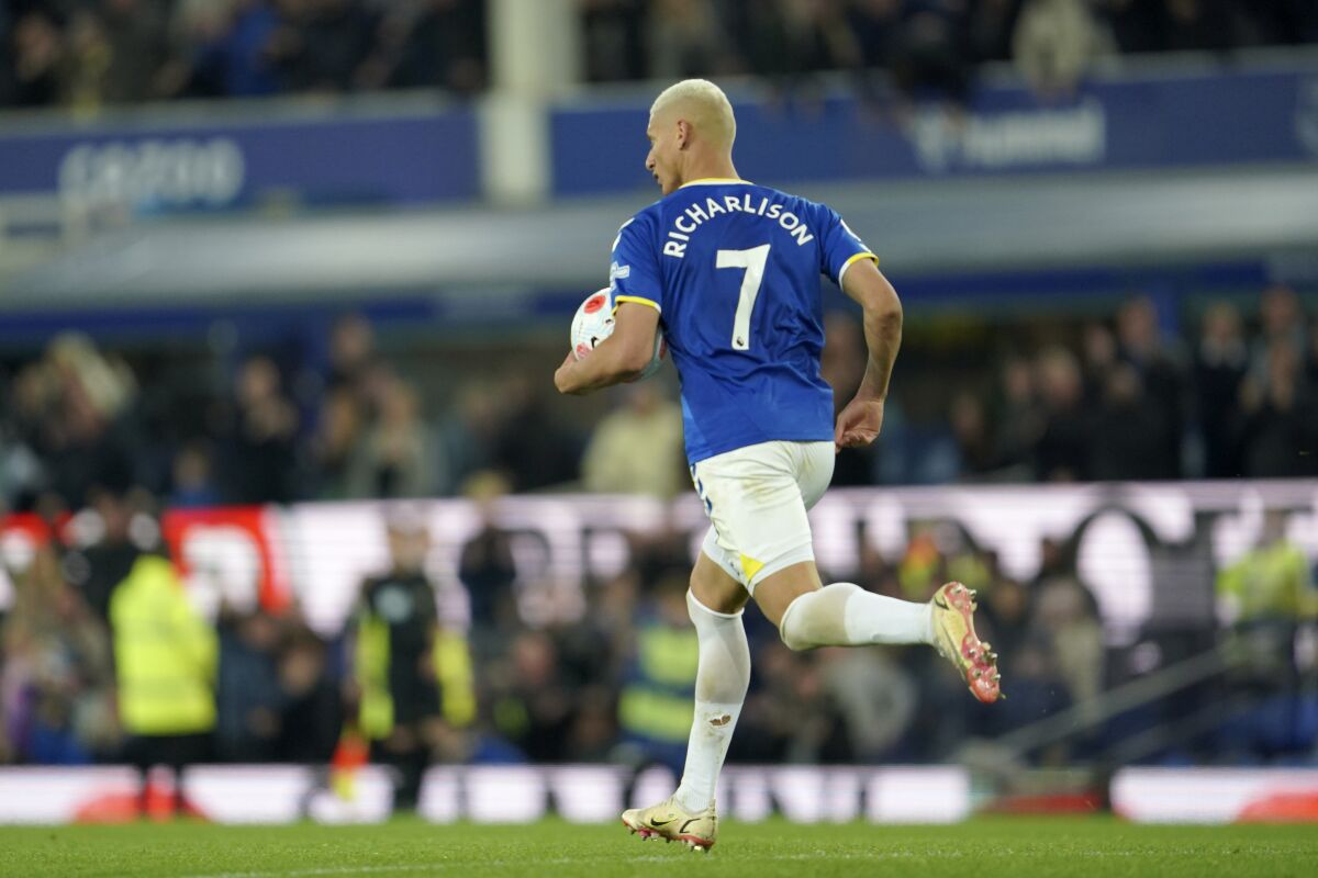 Everton's Richarlison retrieves the ball after scoring his side's first goal during the Premier League soccer match between Everton and Leicester City at Goodison Park, in Liverpool, England, Wednsday April 20, 2022. (AP Photo/Jon Super)