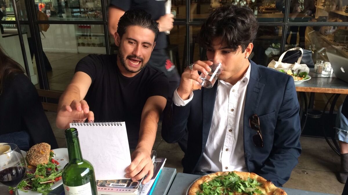 Emmanuel Macias and Isaac Ybarra chat at the post-shoot lunch. The fotonovelas are art, but they also are about creating community.
