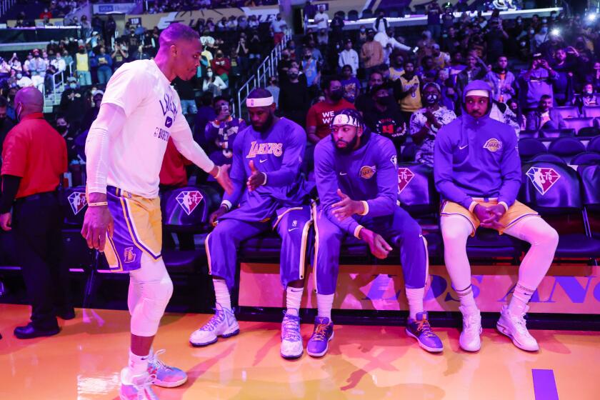 Los Angeles Lakers guard Russell Westbrook (0) greets forwards LeBron James.