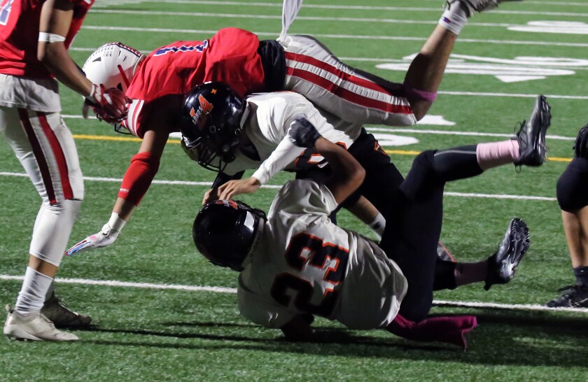 Bolsa Grande's Damion Beaudoin dives for a touchdown against Los Amigos in a Garden Grove League game on Friday.