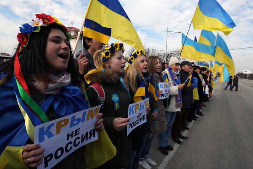 Demonstrators hold signs that read: "Crimea is not Russia" during a protest action in Simferopol, Ukraine, on Friday.