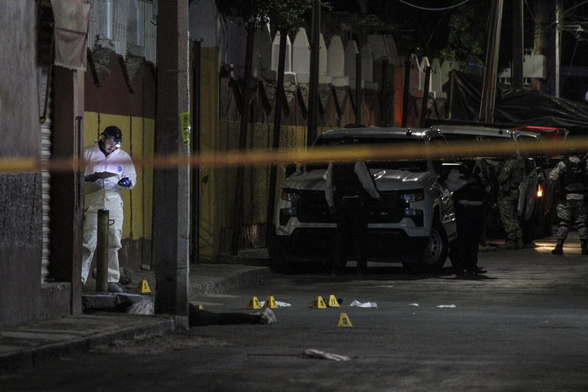Forensic personnel work near the body of Gisela Gaytan, candidate for mayor of Celaya 