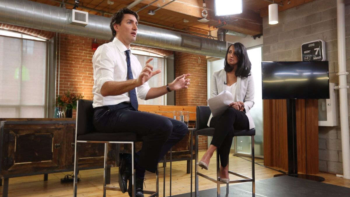 Canada's Prime Minister Justin Trudeau, left, speaks at a global town hall hosted by The Huffington Post Canada in Toronto on Monday, March 7, 2016.