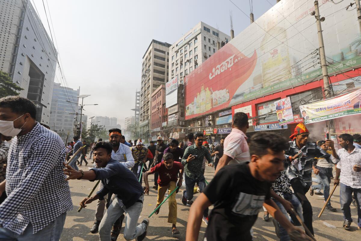Activists run from police in Dhaka, Bangladesh
