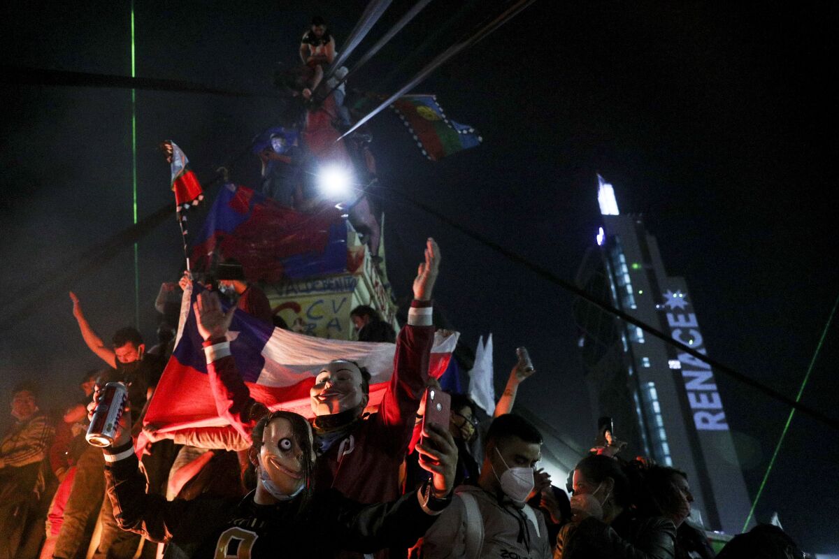 People gather in Santiago, Chile, on Sunday, when Chileans voted to rewrite the country's 40-year-old constitution