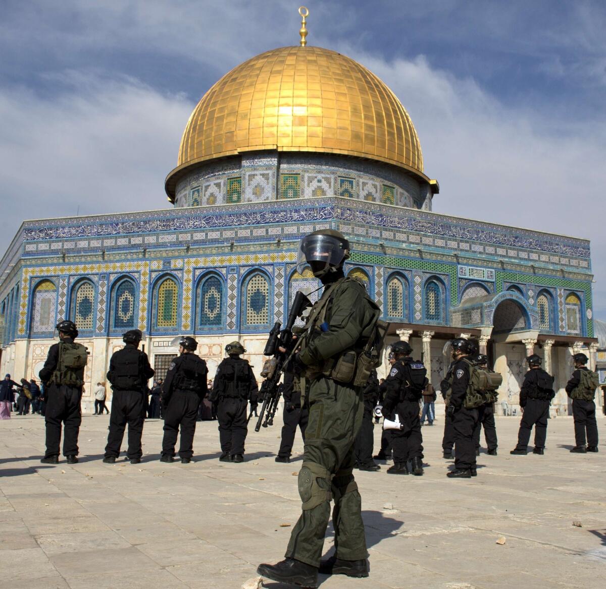 Israeli riot police stand outside the Dome of the Rock mosque in Jerusalem during clashes with Palestinian stone-throwers following midday prayers.