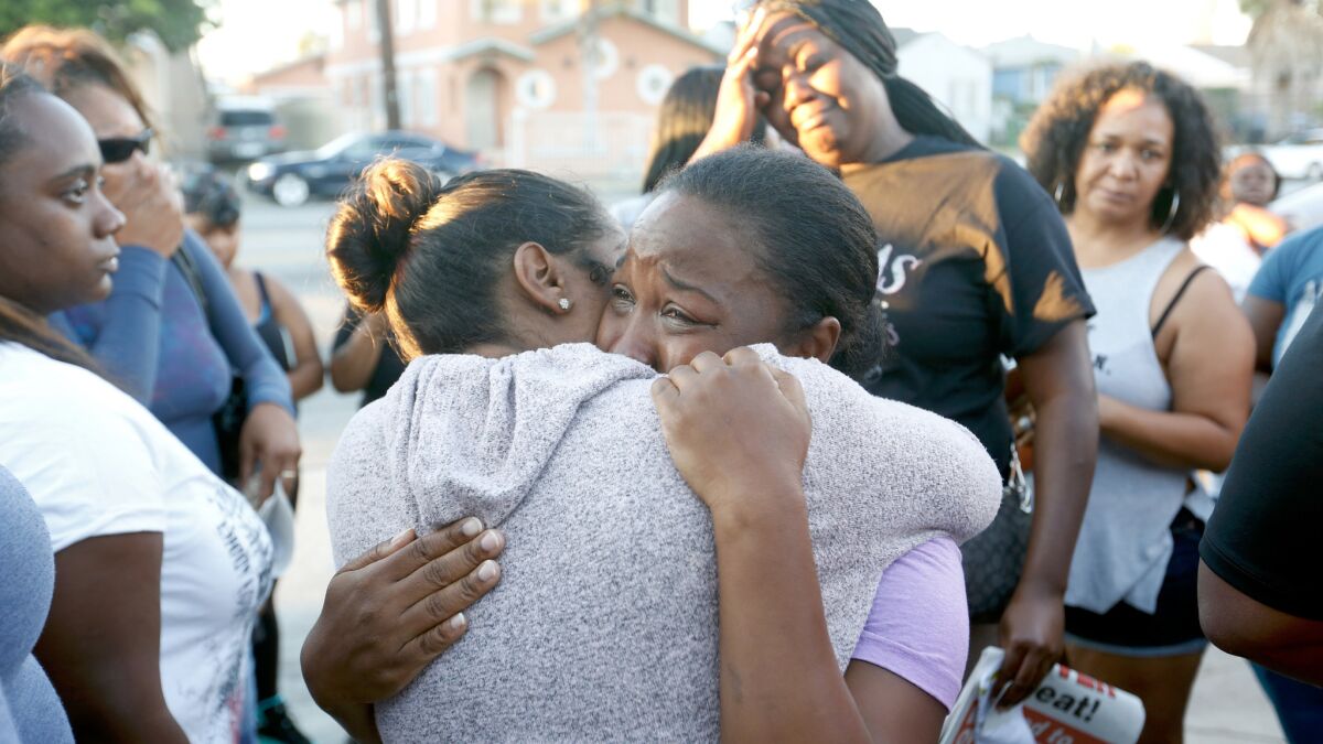 Prescious Sasser, mother of Kenney Watkins, cries during a prayer vigil in South Los Angeles on Wednesday.