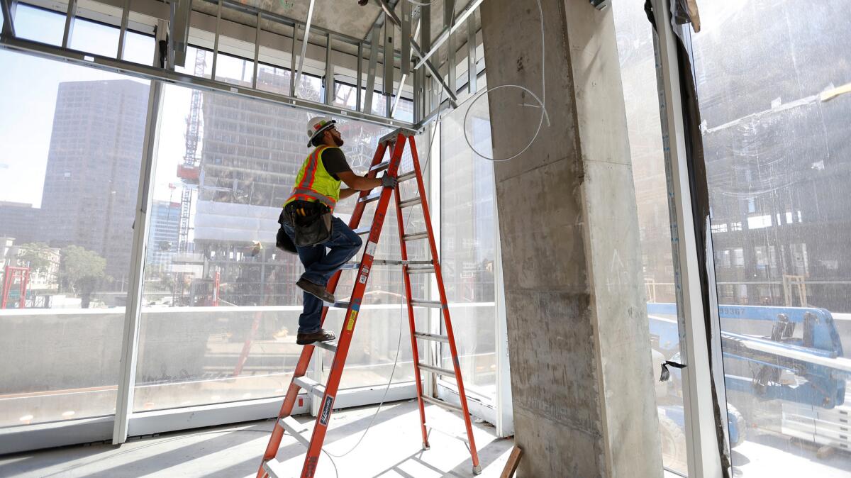 Electrician Jaime Sanchez works at a construction site in downtown Los Angeles on July 26.