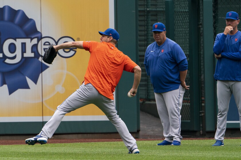 New York Mets starting pitcher Max Scherzer throws during a baseball workout at Nationals Park, Wednesday, April 6, 2022, in Washington. The Washington Nationals and the New York Mets are scheduled to play on opening day, Thursday. (AP Photo/Alex Brandon)
