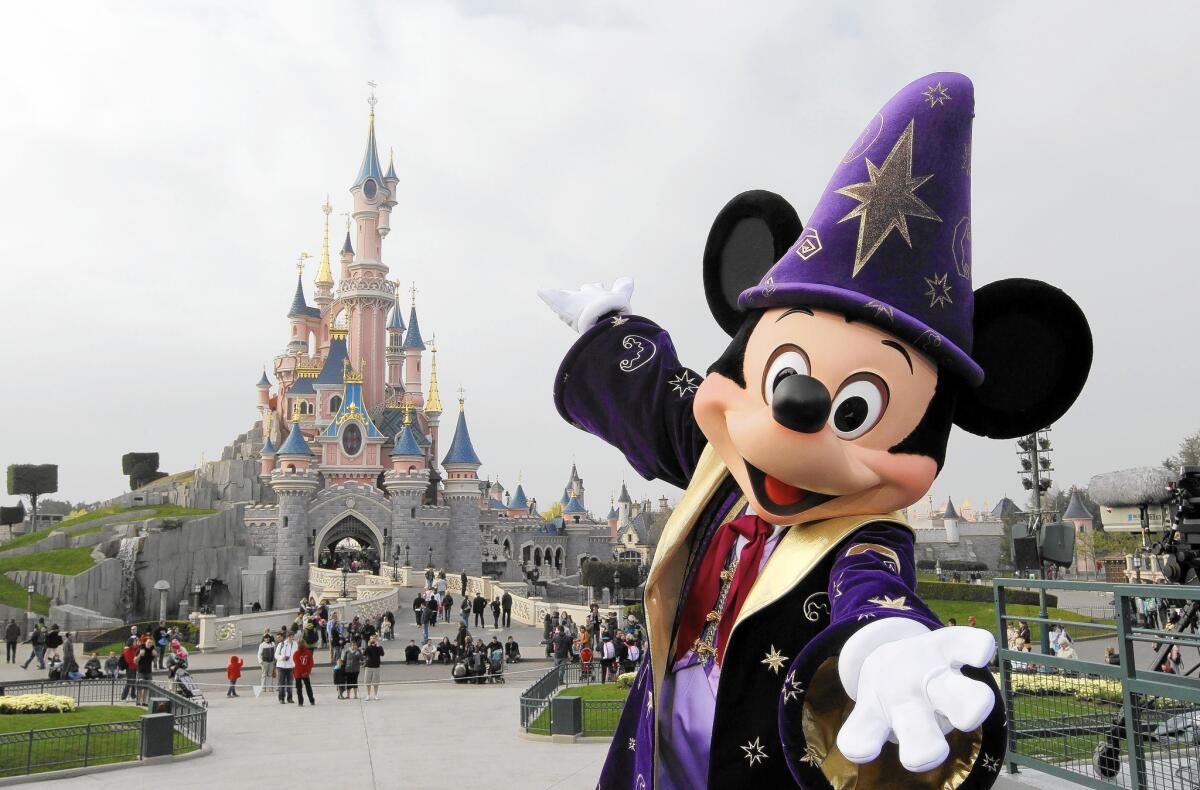 Mickey Mouse poses at Disneyland Paris, just outside the French city. Euro Disney is getting a $1.3-billion financial lifeline from owner Walt Disney Co.