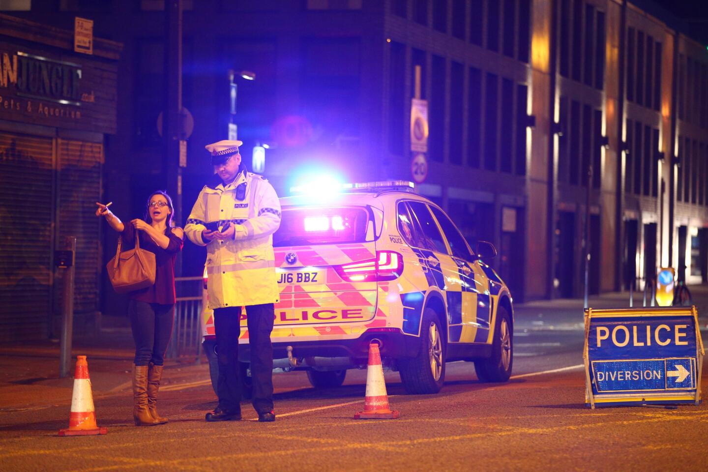 Police stand by a cordoned-off street close to the Manchester Arena on May 22, 2017, in Manchester, England, after an explosion at an Ariana Grande concert.