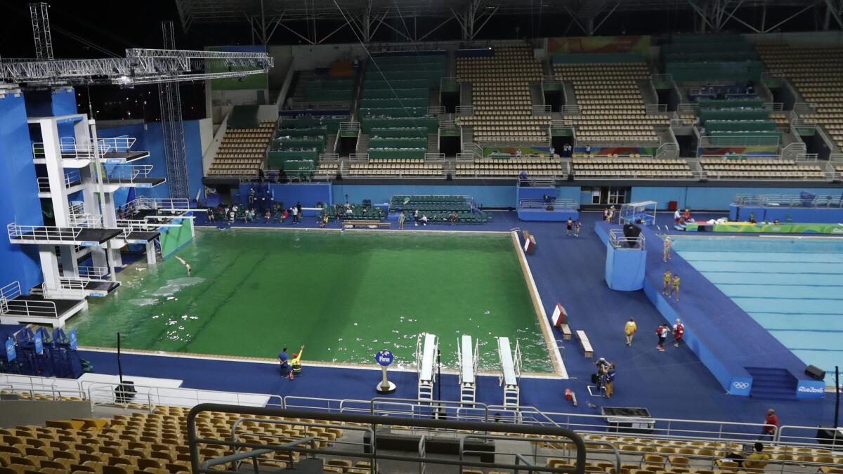 The Olympic pool for diving is noticeably green when compared to the water polo pool on the right.
