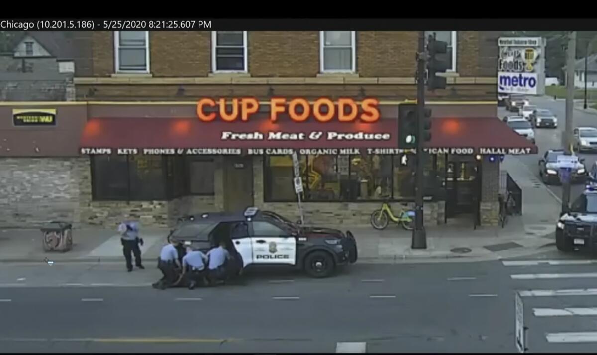 Minneapolis police officers surrounding George Floyd in video