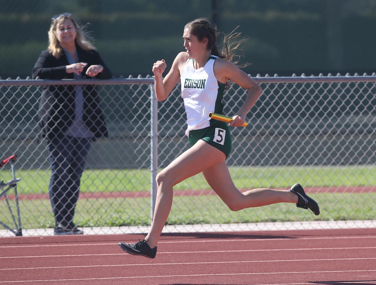 Edison's Hannah Forest runs the last leg of the 400-meter relay team's win during the Surf League dual meet against Los Alamitos on Wednesday.