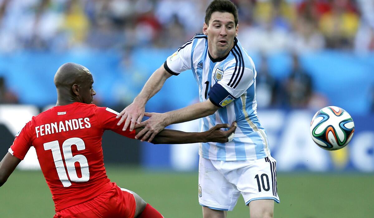 As Switzerland's Gelson Fernandes (16) understands, sometimes it's a victory just to slow down Argentina star Lionel Messi. Forget trying to stop him.