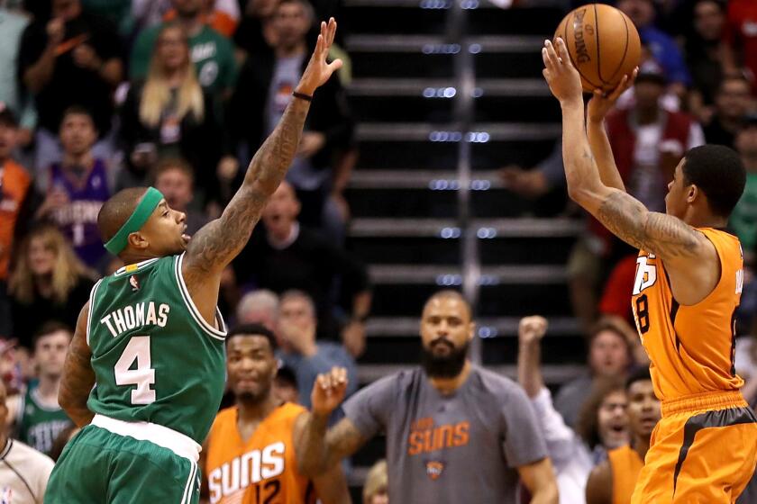 Suns point guard Tyler Ulis pulls up for the game-winning three-point shot over Celtics point guard Isaiah Thomas in the final moments of their game Sunday.