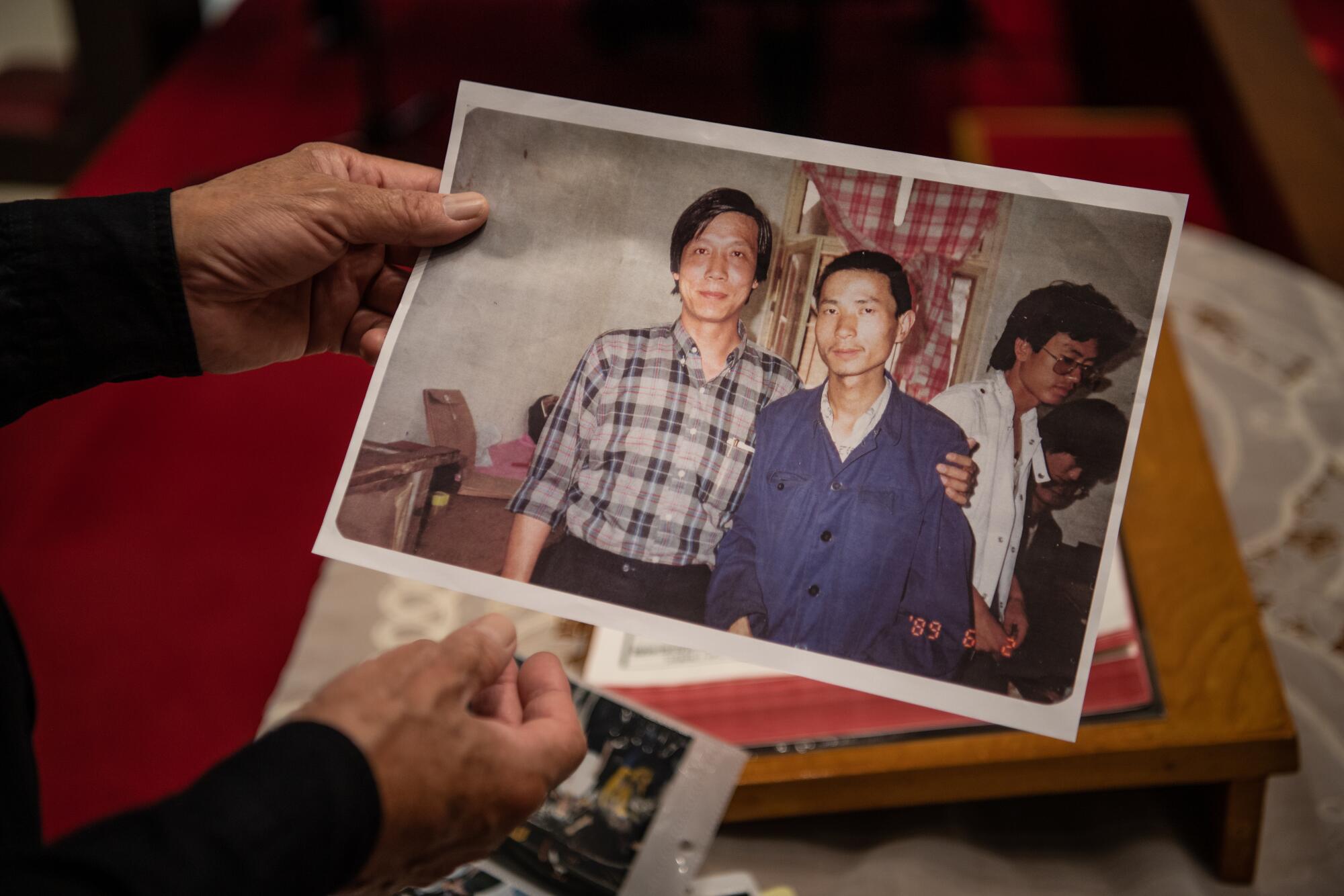 Reverend Chu Yiu-ming looks at a picture of himself with Chinese activist taken two days before the Tiananmen massacre.