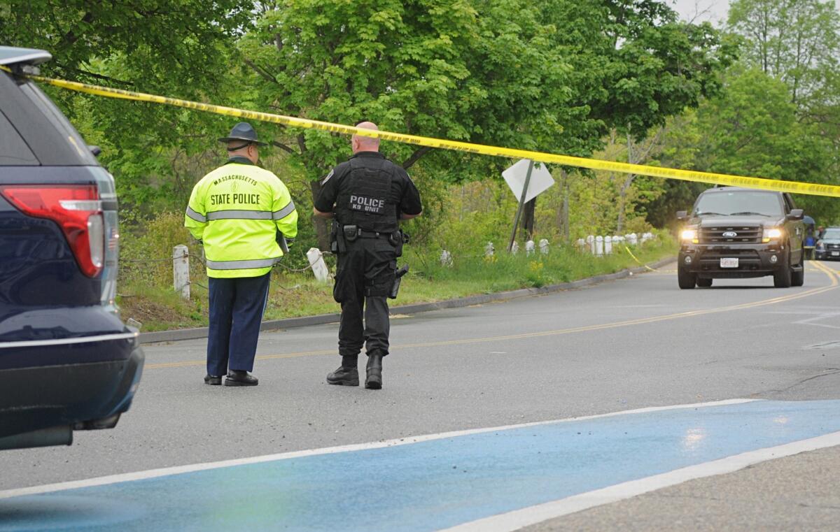 Police guard the scene in Auburn, Mass., where a police officer was fatally shot early Sunday morning.