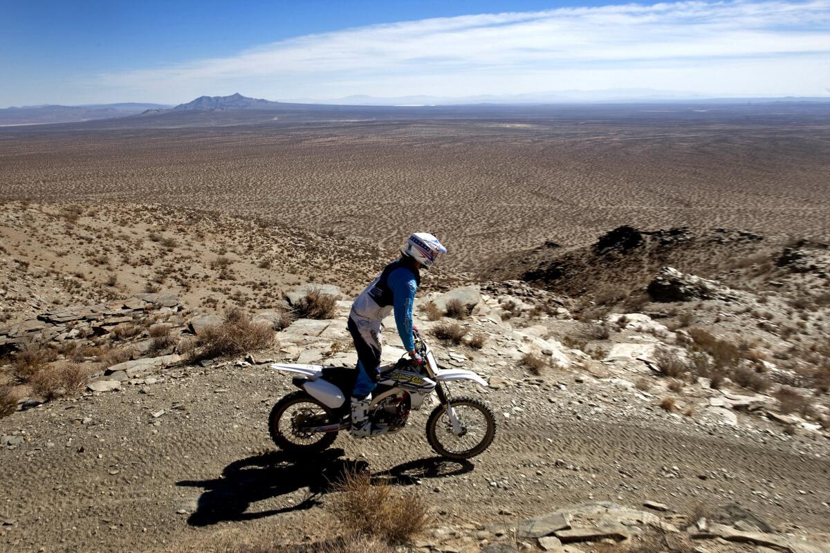 Ryan Abbatoye, a guide with Chris Haines Motorcycle Adventure Co., leads Goat Breker's group of off-roaders in October 2013 through the Mojave Desert area where gold was discovered in the late 1890s near Randsburg.