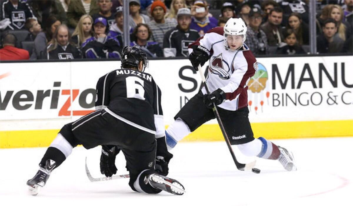 Defenseman Jake Muzzin slides in front a shot by Colorado's Matt Duchene on Dec. 21 at Staples Center. Coach Darryl Sutter expects Muzzin, 24, to play big minutes for the Kings to take some of the workload off the team's older defenders.
