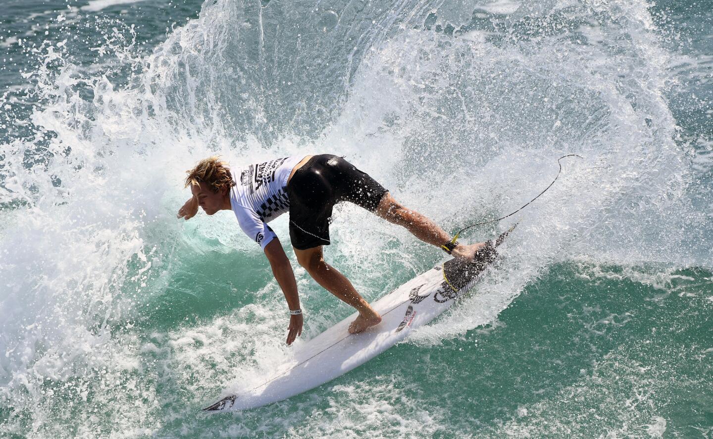 Cody Young surfs his way to a championship in in the junior men's heat at the Vans U.S. Open Surf Champioships in Huntington Beach.