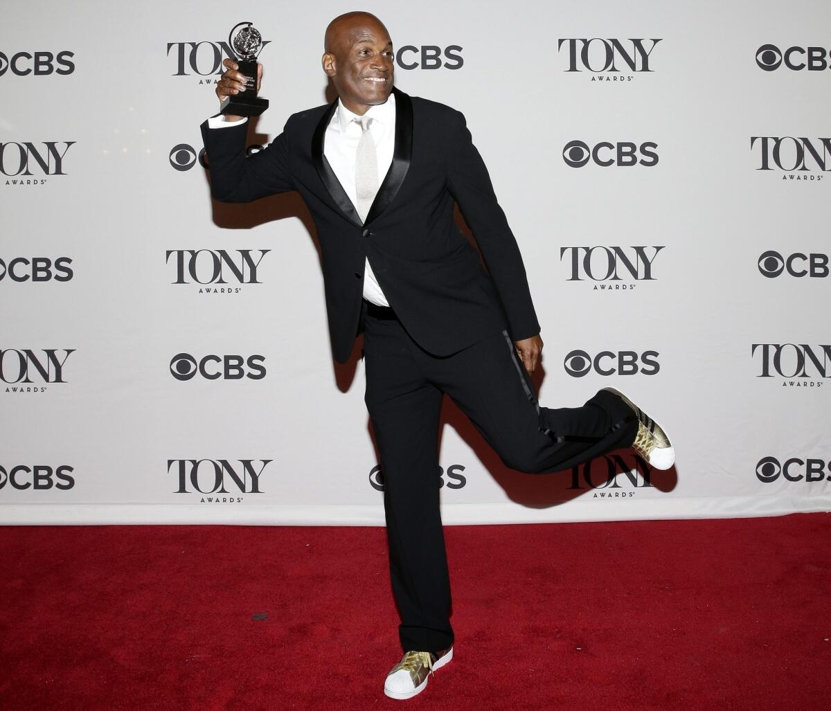 Director Kenny Leon shows off his Tony Award for best direction of a play for "A Raisin in the Sun."