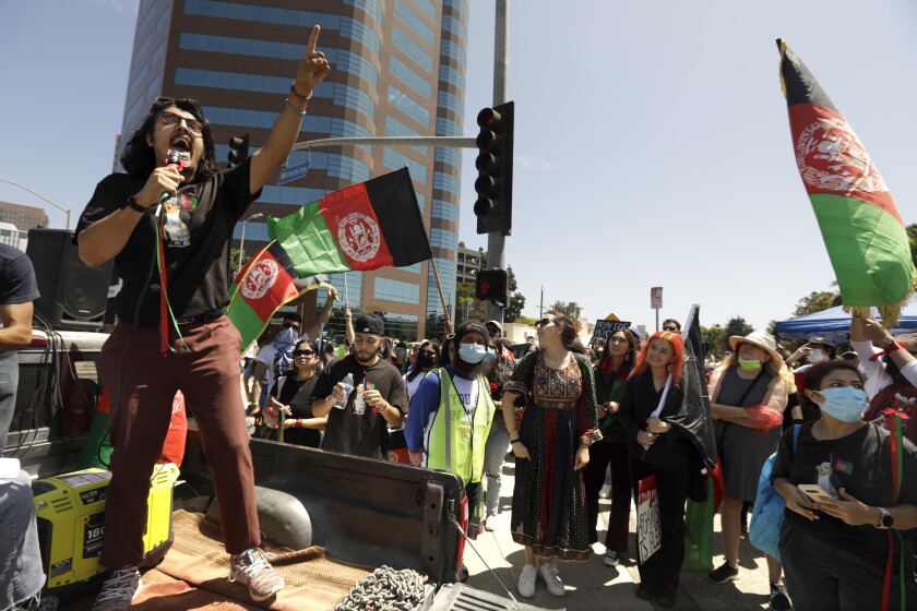 Afghan American activist Arash Azizzada, left, speaking to a crowd in Los Angeles.