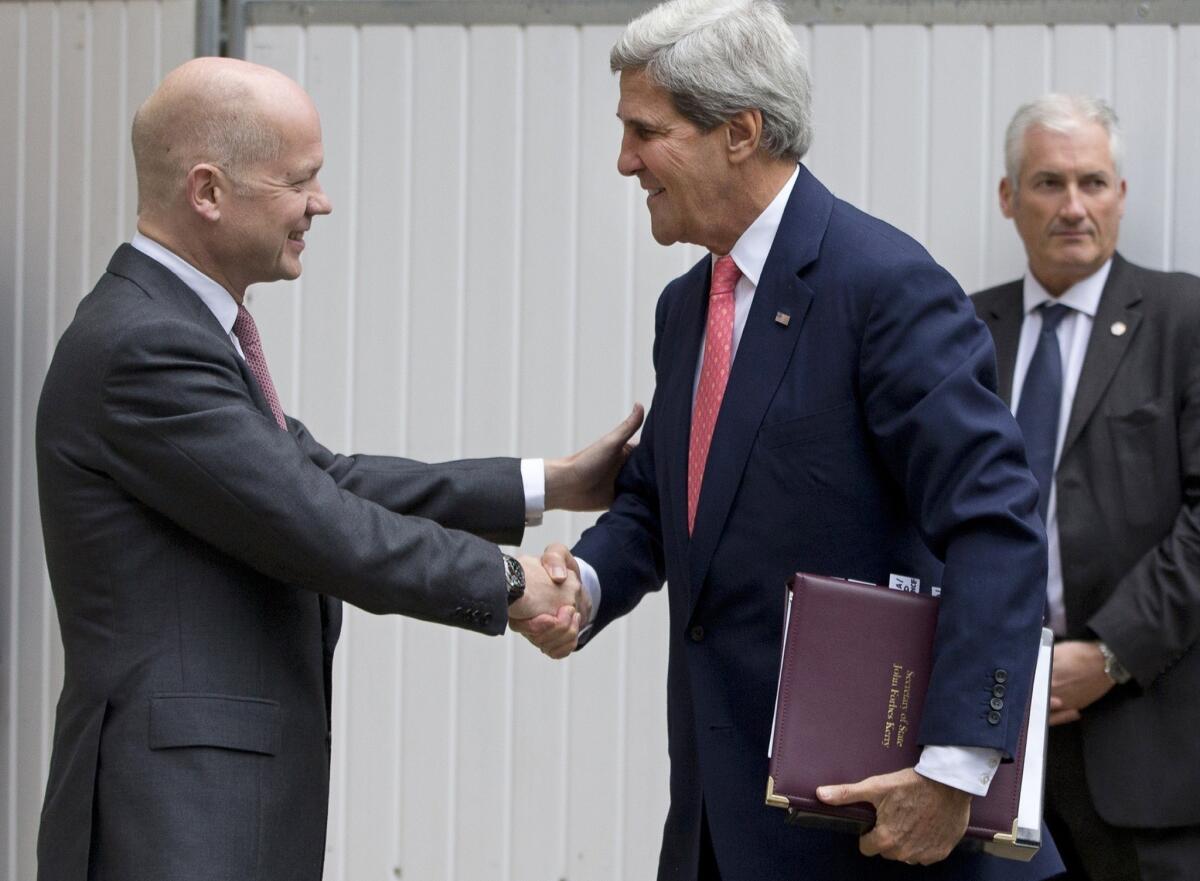 British Foreign Secretary William Hague, left, welcomes Secretary of State John Kerry to the Foreign Office in London.