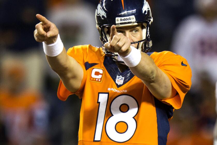 Quarterback Peyton Manning points to the defense in setting the Broncos at the line of scrimmage in a game earlier this season against the Raiders.
