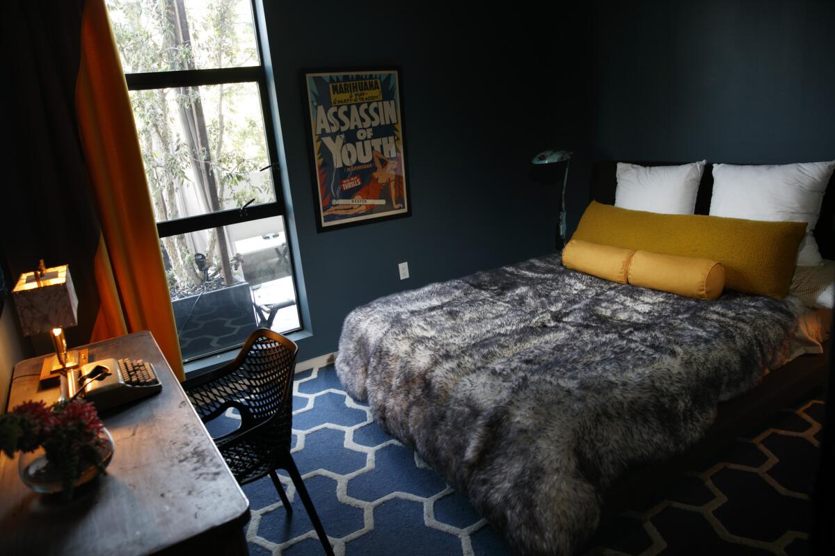 The guest room feels like an escape for overnight guests as saturated layers of blue create an elegantly moody cave.