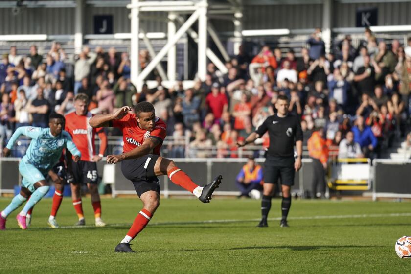 Luton Town's Carlton Morris scores his side's first goal of the game, during the English Premier League soccer match between Luton Town and Wolverhampton Wanderers, at Kenilworth Road, in Luton, England, Saturday, Sept. 23, 2023. (Joe Giddens/PA via AP)