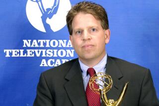 Norby Williamson holds an Emmy award during 26th Annual Sports Emmy Awards in 2005.