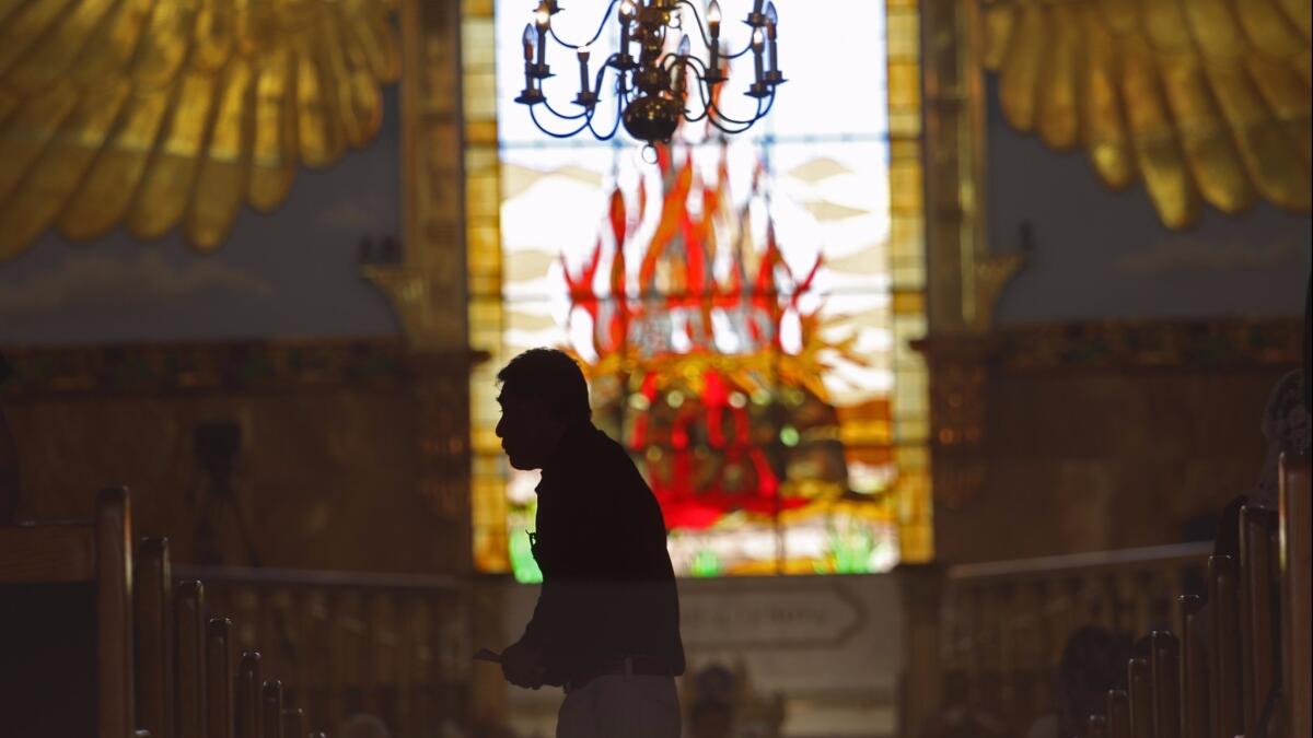 A congregant during a prayer service at La Luz Del Mundo in East Los Angeles.