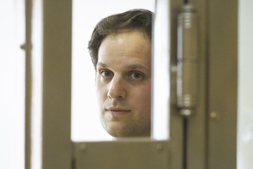 FILE - Wall Street Journal reporter Evan Gershkovich stands in a glass cage in a courtroom at the Moscow City Court in Moscow, Russia, June 22, 2023. (AP Photo/Dmitry Serebryakov, File)