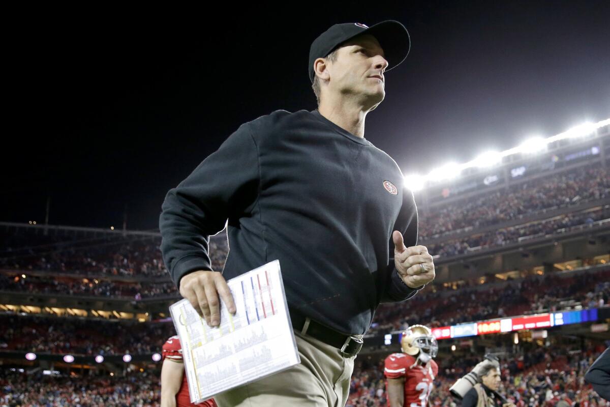 Jim Harbaugh runs off the field after the 49ers' 38-35 overtime loss to the Chargers at Levi's Stadium.