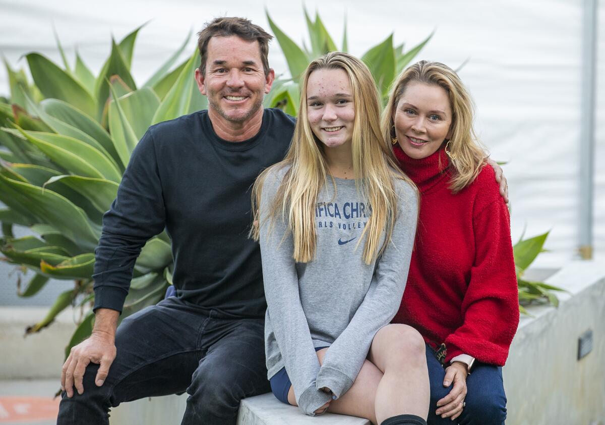 Jeff and Erica Roberts pose with their oldest daugther Lauren , 16, on Friday. 