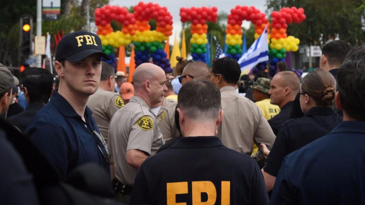 FBI agents keep watch during the L.A. Pride parade in West Hollywood on June 12.