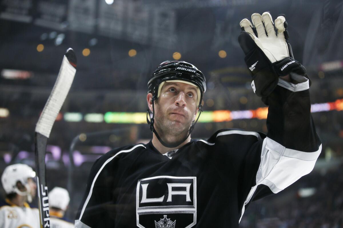 Newly acquired Kings defenseman Rob Scuderi waves as fans applaud and welcome him back to Los Angeles during a game on Feb. 27. The Kings beat the Buffalo Sabres, 2-0.