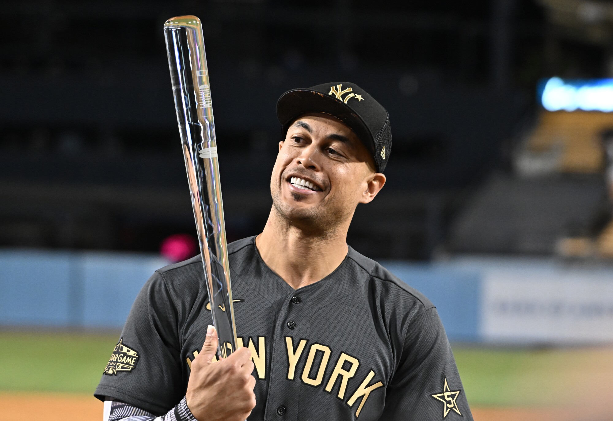 New York Yankees outfielder Giancarlo Stanton holds the All-Star MVP award after leading the American League to victory.