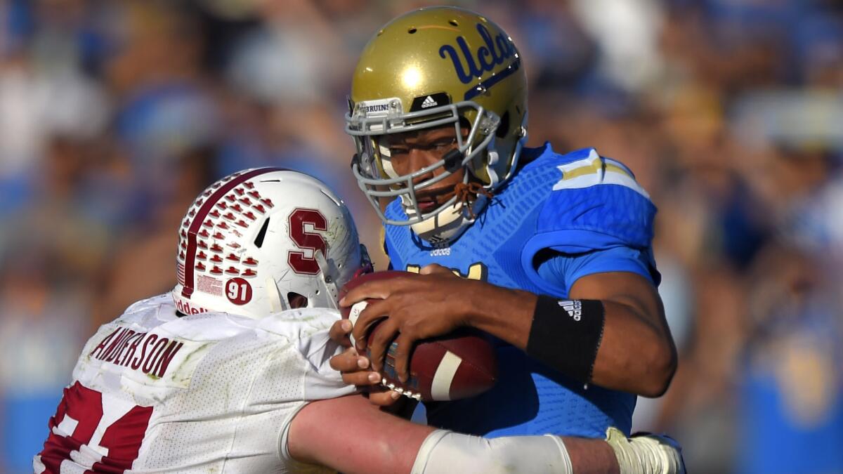 UCLA quarterback Brett Hundley is sacked by Stanford defensive end Henry Anderson during the second half of the Bruins' 31-10 loss Friday.